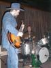 George picks while Jimmy grins 'n drums.
